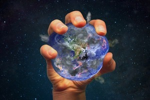Human hand squeezing the planet